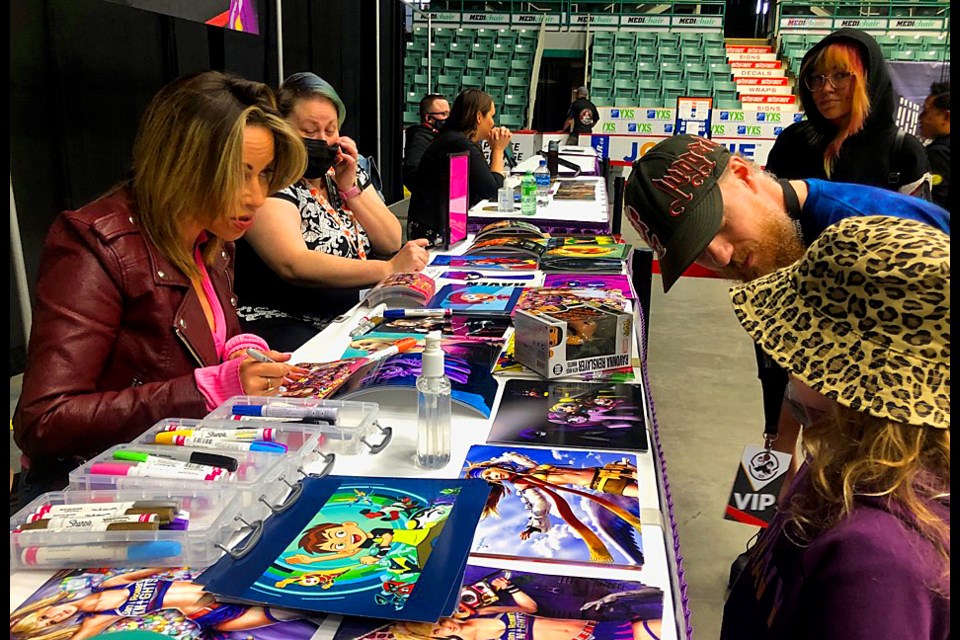 Dawson Creek's Bella Commandeur catches an autograph from voice actress Tara Strong.