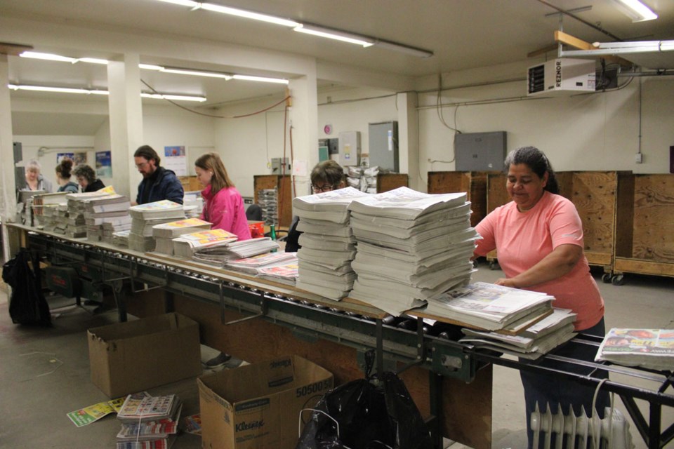 The crew was hard at work behind the doors of the Dawson Creek Mirror, loading by flyers by hand for this week's paper. 

Alaska Highway News and the Mirror remain one of the few, if not the only newspapers in the province to load flyers by hand, employing members of the community. 