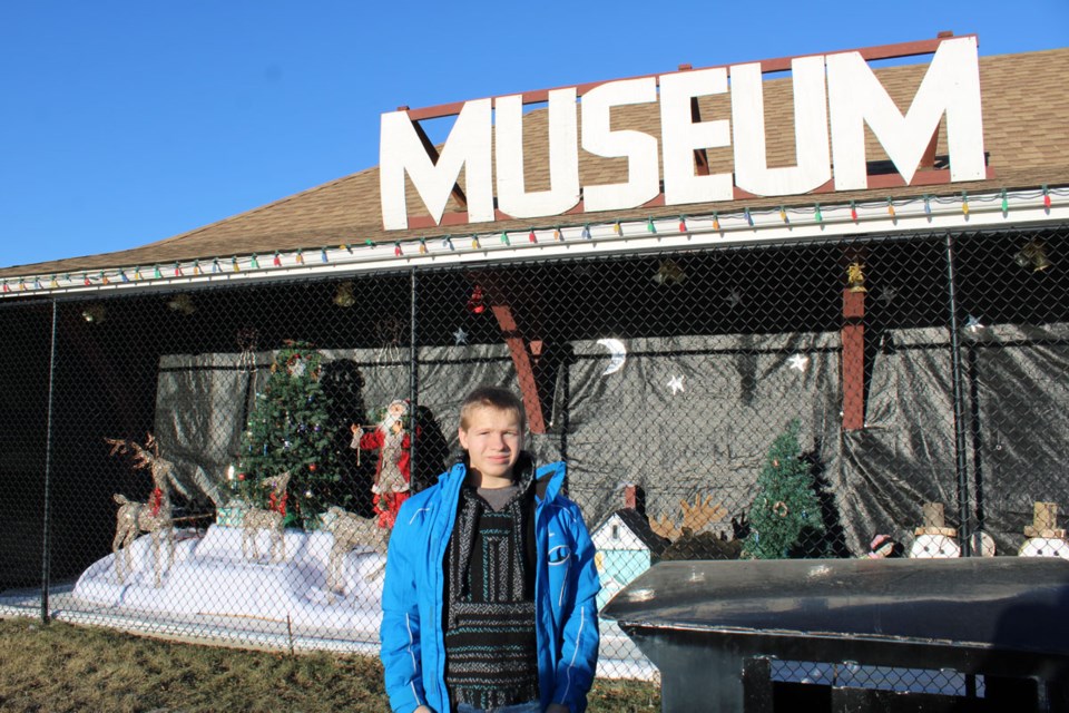 Pouce Coupe Museum Curator Les Dayus' grandson, Jay Jones, was out to lend his grandfather a hand this week, setting up their Christmas display. 