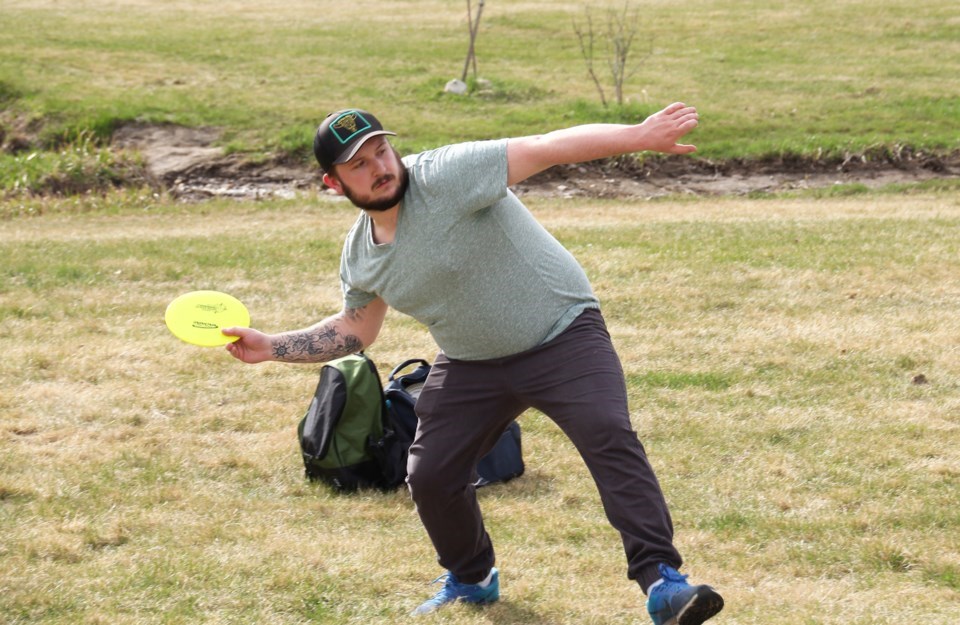 Colton Rand winds up for a drive using the thumber method at the Dawson Creek Disc Golf course. 