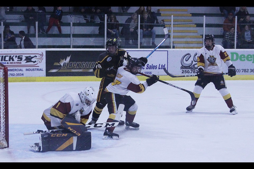 Smothered puck by Corey Ross with traffic out front.