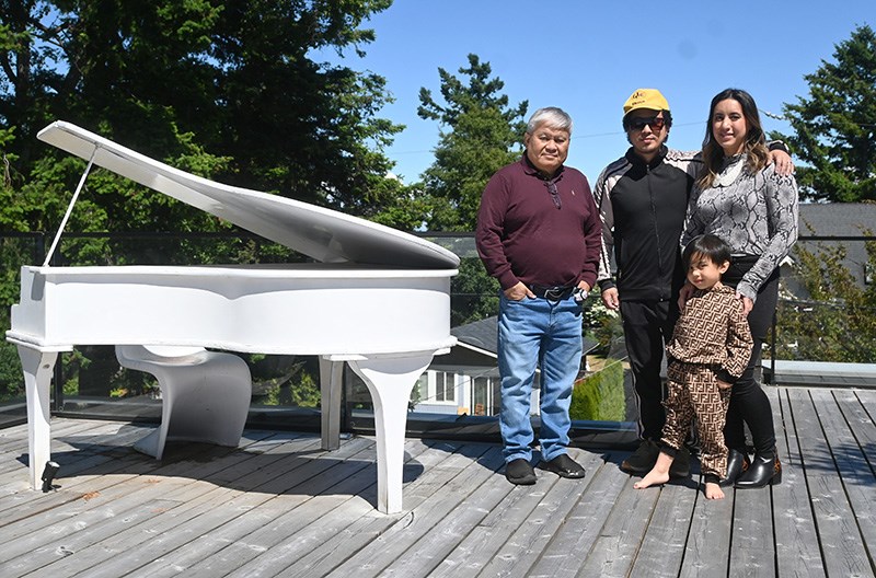 The Flandez home in Beach Grove includes a roof-top entertaining area complete with a touring piano shell with room to insert a keyboard for live music.