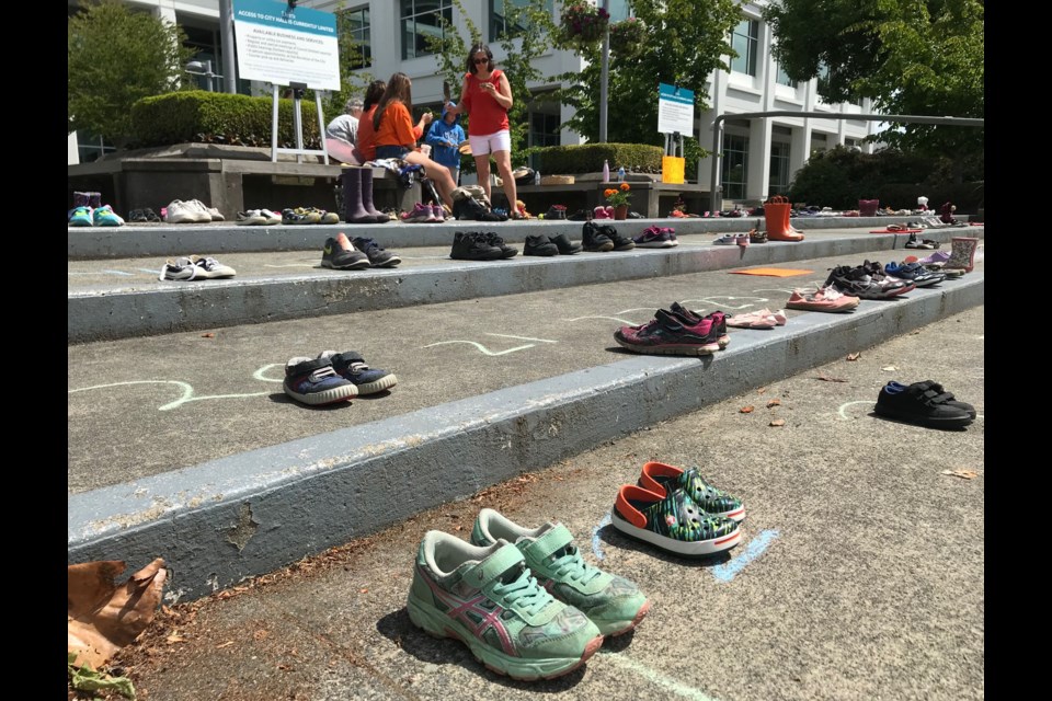 A memorial of little shoes to honour the 215 First Nations children whose remains were found buried at the former Kamloops residential school was established outside Delta Municipal Hall. 