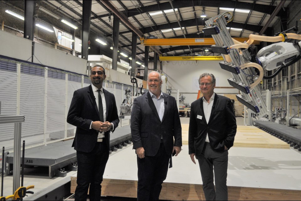 Ravi Kahlon, Minister of Jobs, Economic Recovery and Innovation and Delta North MLA, Premier John Horgan and Intelligent City co-founder and CEO Oliver Lang at the opening their robotics-based factory in Delta on Thursday, Oct. 14.