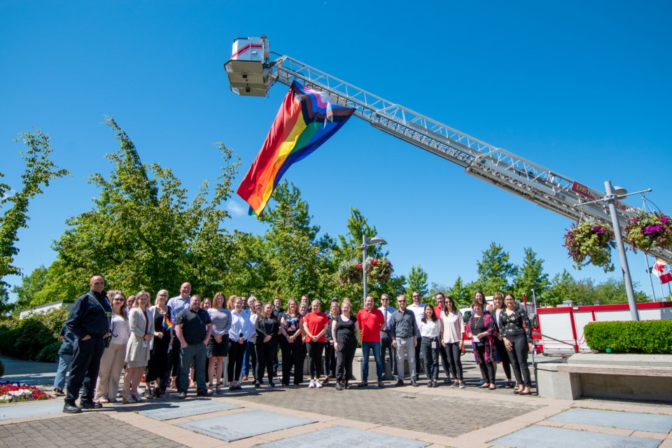 City staff by new pride flag