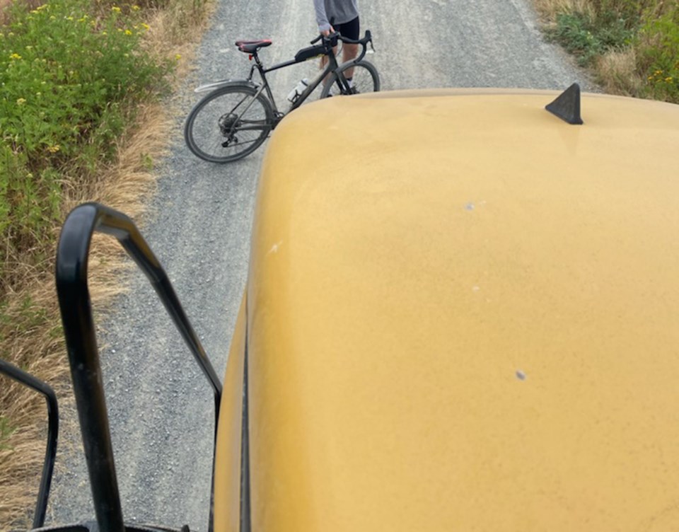 Cyclist blocks farm vehicle