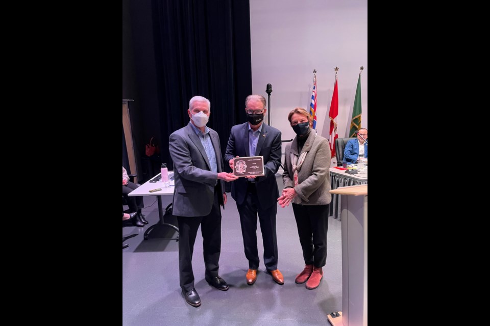 Delta Optimist publisher Pierre Pelletier receives the 2022 Heritage Award of Merit from Mayor George Harvie and Coun. Jeannie Kanakos at the March 7th council meeting in North Delta.