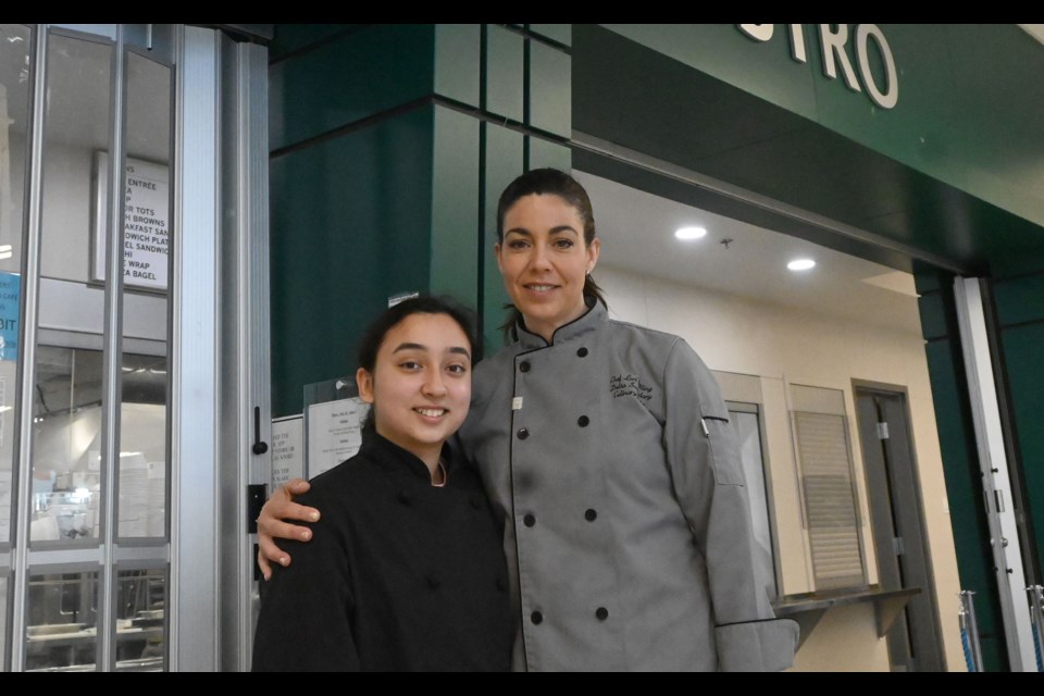 Grade 12 student and national baking champion  Leila Pourshahriary with Delta Secondary School's culinary arts teacher Lori Pilling outside the Pacers' Bistro. 