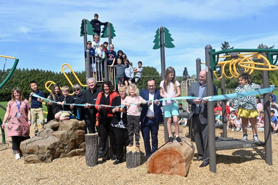 There was plenty to celebrate at Port Guichon Elementary on Monday (May 8) with the grand opening of the school's new playground following years of fundraising. Principal Danica Palmer (far left) and students invited city officials, Delta School Board trustees and Port Guichon PAC members for the ribbon cutting ceremony.