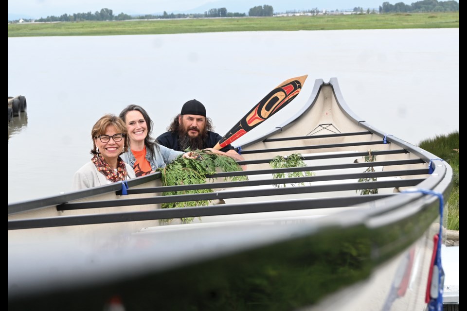 (Left to Right) Delta School District Indigenous Education Vice-Principal Diane Jubinville, Delta School District Academy and Choice Programs Vice-Principal Paige Hansen and Delta School District Indigenous Cultural Mentor Nathan Wilson with the 39-foot Journey Canoe at Wellington Point in Ladner on Tuesday.
