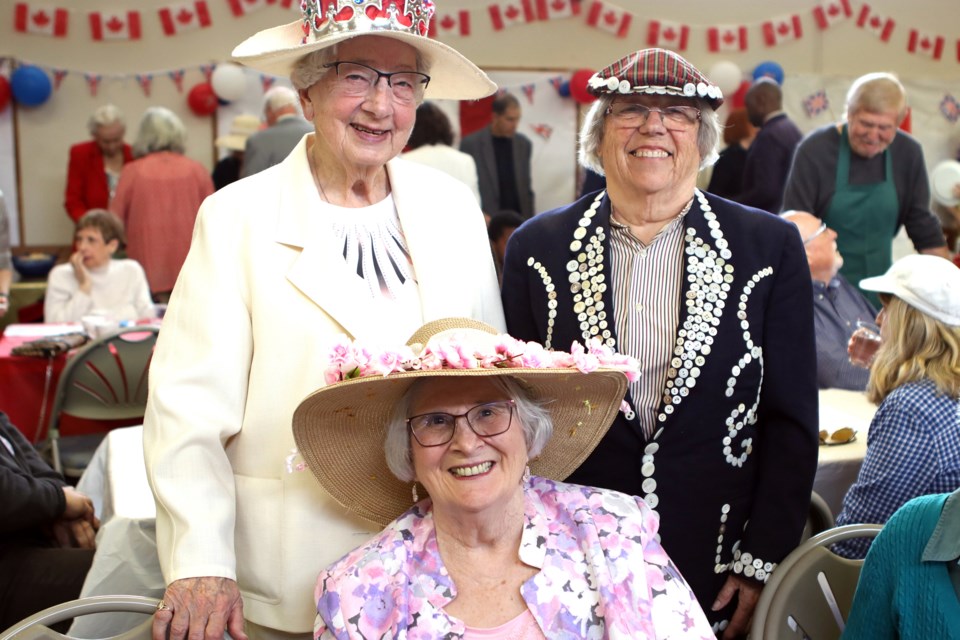 Elizabeth Murray, Dawn Repin (Pearly Queen), Rev. Maggie Rose Muldoon - seated get set to enjoy the Big Lunch Sunday at St. David's Anglican Church.
