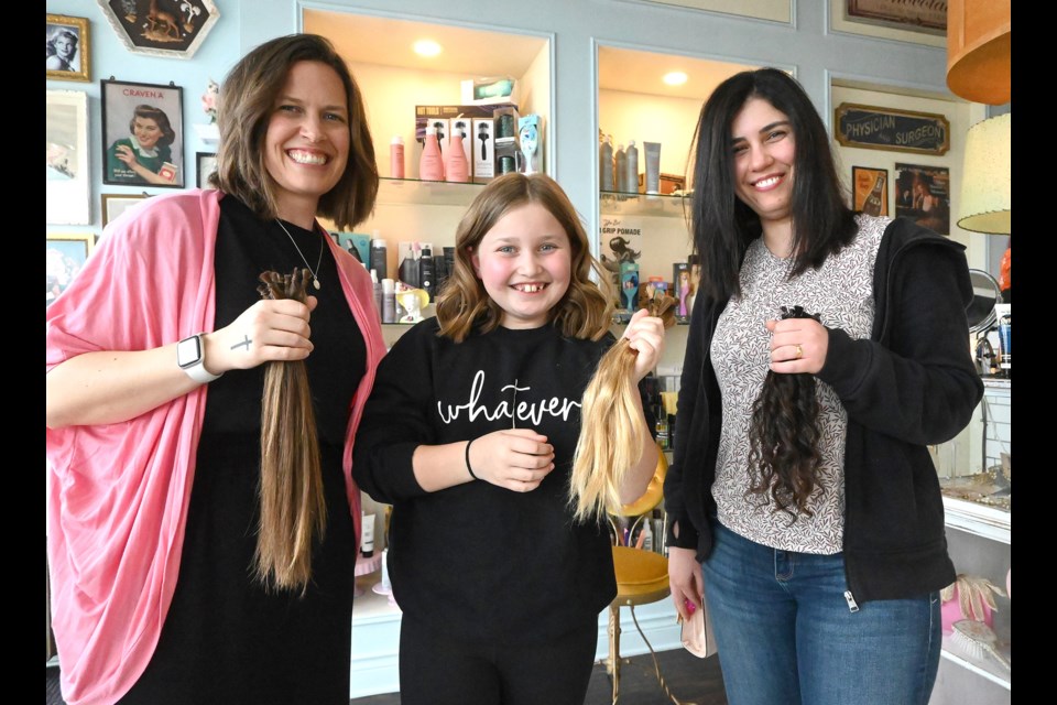 10-year-old Optimist carrier Alya Keen and her aunts Sharisse (left) and Sarah each had 25 centimeters of their hair cut last Wednesday at Bobby Pinze Beauty Parlour for the Wigs for Kids charity program. The trio has also raised over $2,100 for B.C. Children's Hospital. 