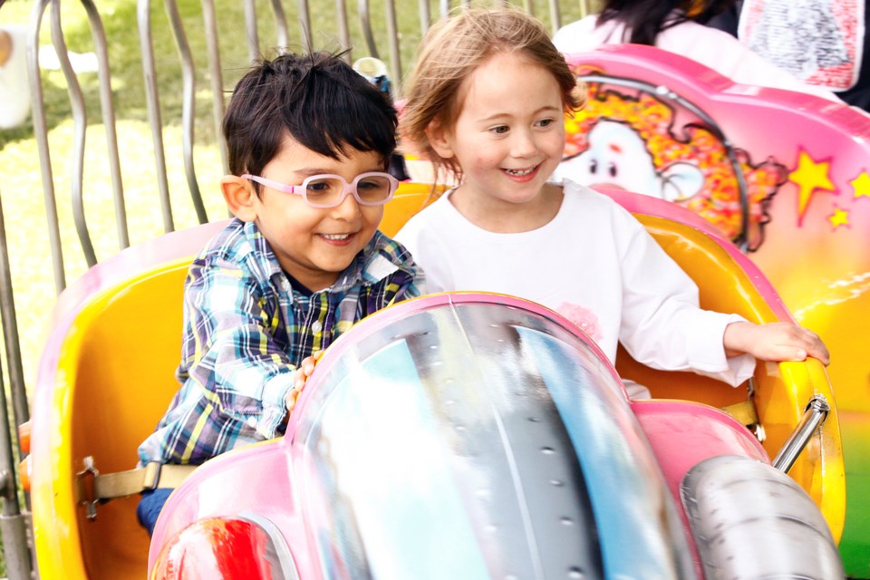 Arin Kulsmrestha and Amilia McDill enjoying the rides at this year's Ladner May Days.