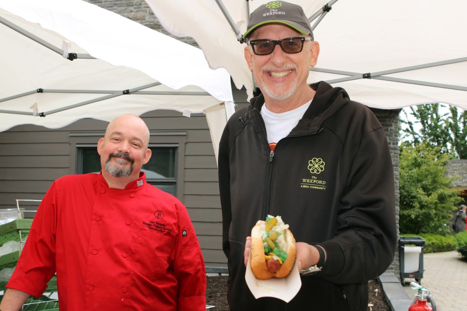 The Wexford's Executive Chef Sean McCarthy and John Meier with one of their tasty hot dogs. A total of $5,100 was raised during the fundraiser for the Alzheimer Society of BC.