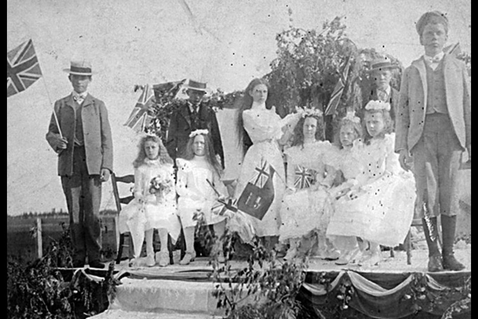 Here’s the May Day celebrations of 1900 showing the May Queen of 1899, Mabel Thirkle, placing a crown of flowers on the May Queen elected for 1900, Alice Ladner.