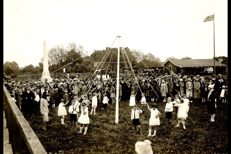 Children having fun around the May Pole in 1932.