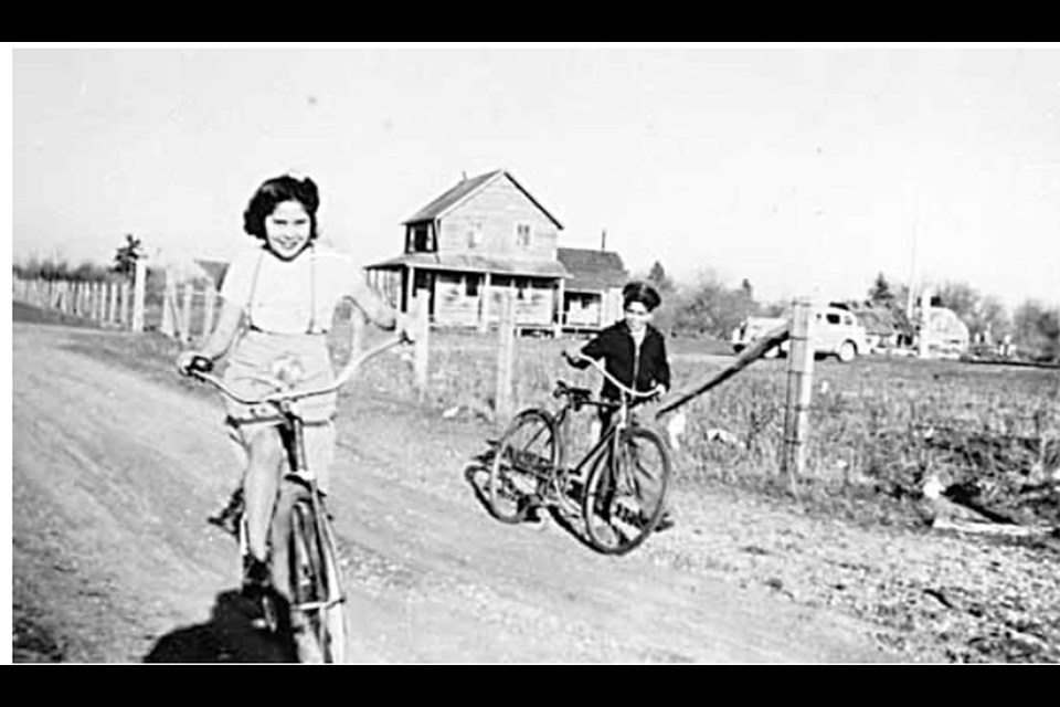 Myrtle and Edward James as children, riding bicycles on the Tsawwassen Indian Reserve in 1940.