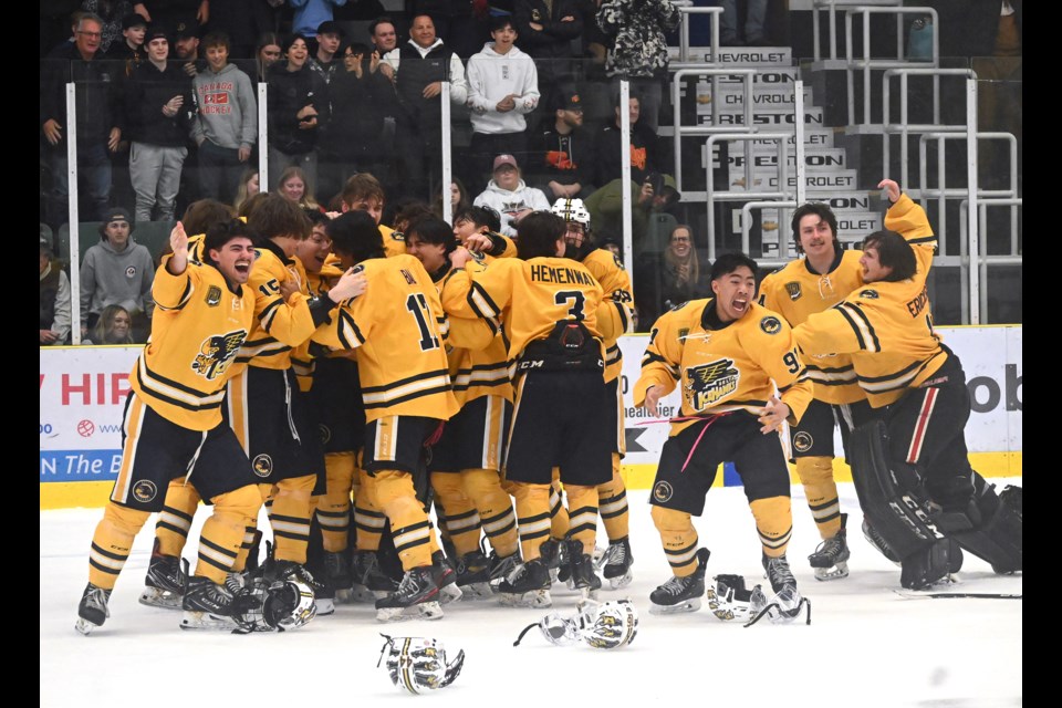 The Delta Ice Hawks celebrate Kyle Robinson's game 7 overtime winning goal to capture the Pacific Junior Hockey League's Stonehouse Cup with a 4-3 triumph over the Ridge Meadows Flames on Sunday night in Langley.