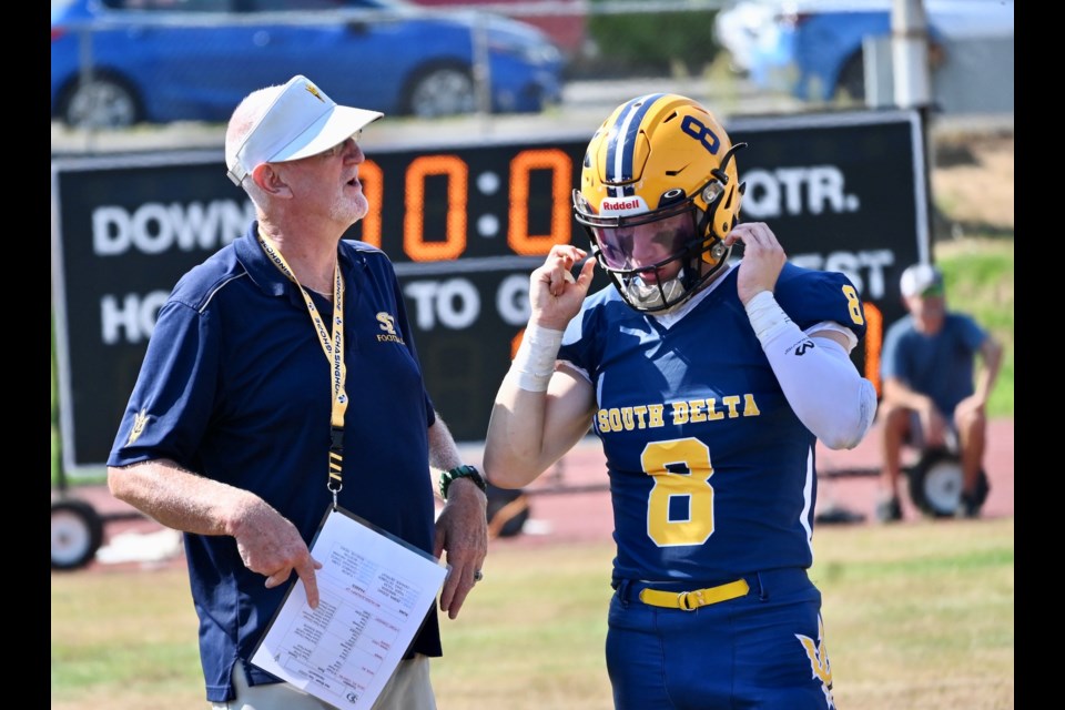 Sun Devils quarterback Kenny Scott and offensive coordinator Jerry Mulliss during a timeout.