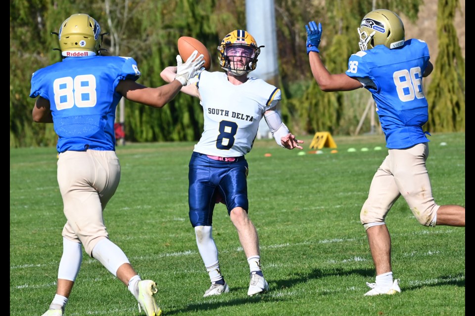 With Seaquam's Ryder Kusch and Dinesh Rupp closing in, South Delta quarterback Kenny Scott gets ready to deliver the ball down field in Saturday's 2022 Delta Bowl high school football rivalry game played at John Oliver Park. The Sun Devils secured city bragging rights for the second straight year with a 22-14 victory. 