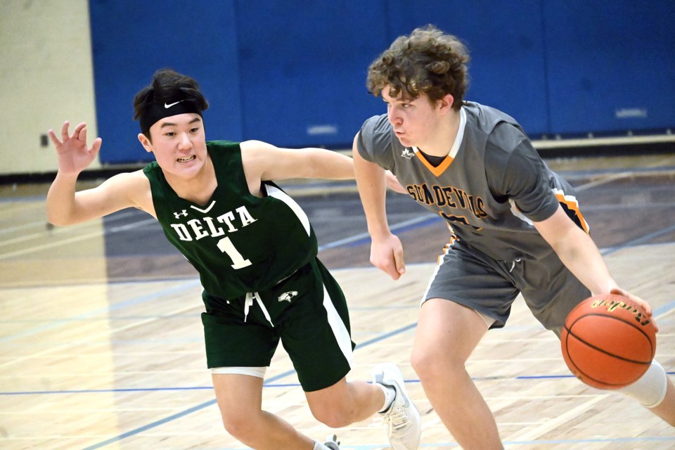 South Delta’s Will Anderson looks to drive past Delta's Quincy Chong during last Thursday's Stebbings/Murray Cup battle at SDSS. The hosts won the game 78-54.