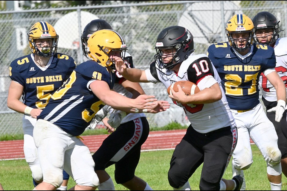 South Delta's Jack Morgenthaler closes in on Terry Fox Ravens' running back Alex Gagnon during Saturday's 21-7 loss in Tsawwassen.