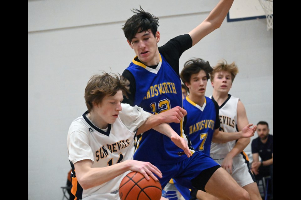 South Delta's Trent Clisby works his way towards the basket against 6-foot-10 Handsworth Royals post Kieran Mullen during third place action at the SDSS T-Town Classic on Saturday. 