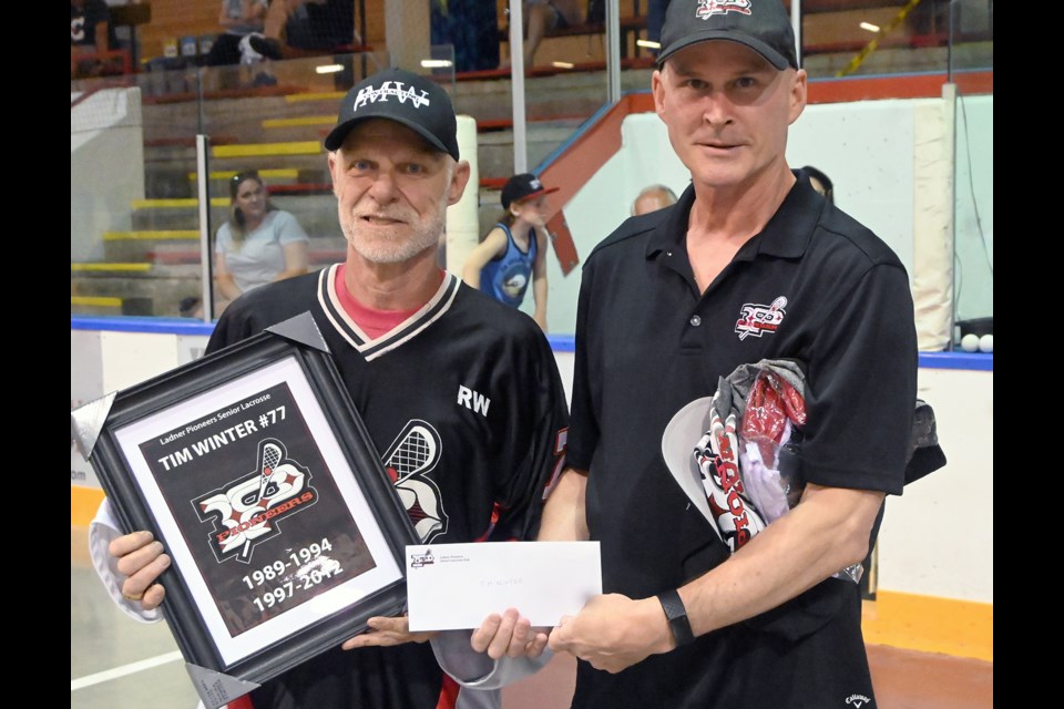Tim Winter (left) was recognized for his 22 seasons with the Ladner Pioneers Senior Lacrosse Club with a special ceremony on July 14 that included the retirement of his #77 jersey. He was also presented with a plaque and a $1,000 travel voucher from head coach and former teammate Ross Frehlick on behalf of the club. 