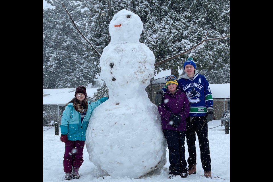Jackson and Grace Marriott and her friend Tesora Gray made a giant snowman on Sunday at the Village Park.