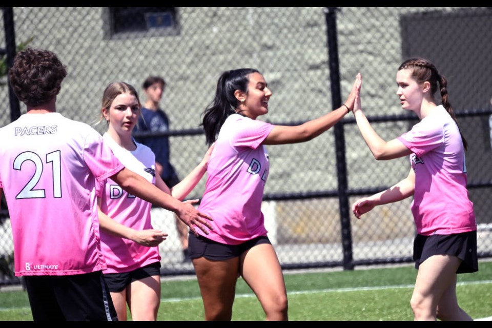 Pacers Alyssa Aulik (centre) celebrates a point with her teammates at the South Fraser Championships on May 12.  Mark Booth Photo