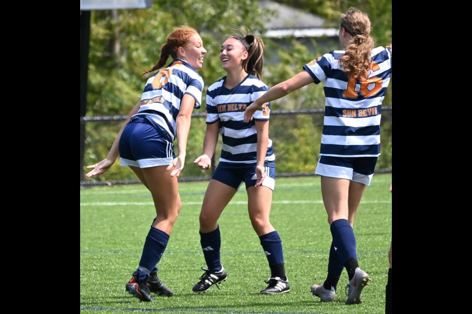 South Delta's Isabella Burtini (left) is congratulated by Kayla Wicks (centre) and Julia Fechter after scoring her first of two goals in a 3-0 win over McMath in the South Fraser AAA final played on May 18 in South Surrey. Mark Booth Photo