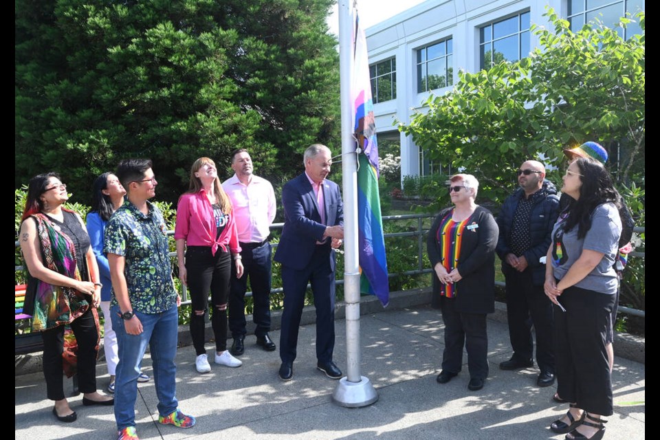 With councillors Jennifer Johal, Dan Boisvert, along with representatives from Delta Pride Society, Sher Vancouver, Ladner United Church and Delta's Diversity, Inclusion and Anti-Racism Committee, Mayor George Harvie raises the Progress Pride flag at municipal hall on Thursday morning to launch Pride Month. Mark Booth Photo