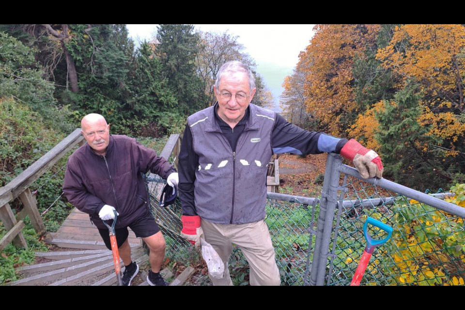 Pat Sullivan and Blake Willson climbed up and down the stairs to restore slope with native plants. 
Phil Melnychuk photo 
