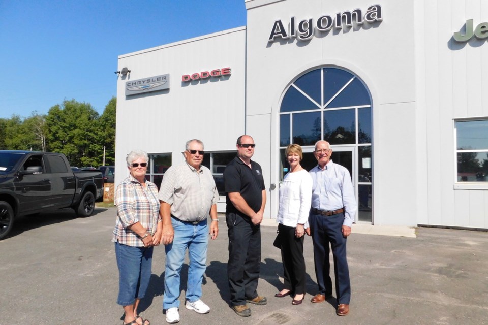 The official handoff of the sale of Algoma Chrysler to Manitoulin Chrysler took place at the dealership in Spragge on Sept. 6. Pictured (from left) are Shirley and Owen Legge, former owners of Manitoulin Chrysler; new Algoma Chrysler owner Wayne Legge; and George Farkouh and his wife Louise, who have sold Algoma Chrysler after 37 years.