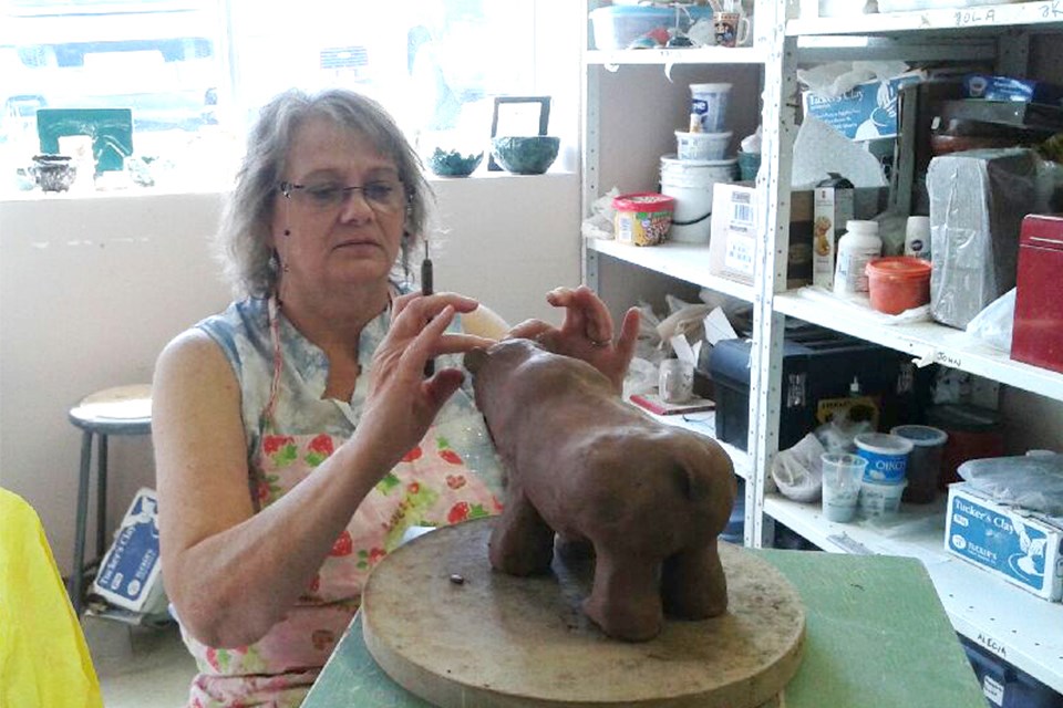 Clarissa Boyce puts the detail on a ceramic bear she created.  Kris Svela for ElliotLakeToday
