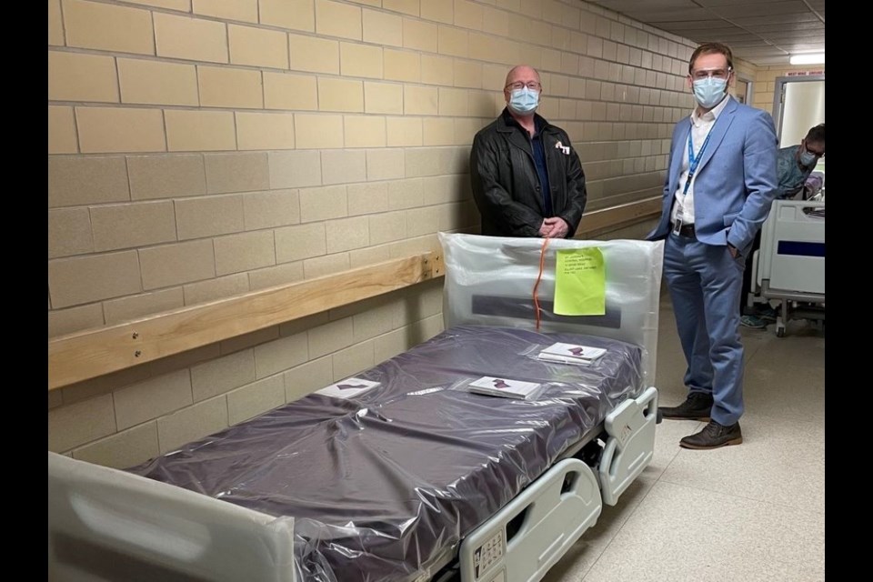 Foundation Chair William Elliott left, and Hospital CEO Jeremy Stevenson stand by the new beds. 