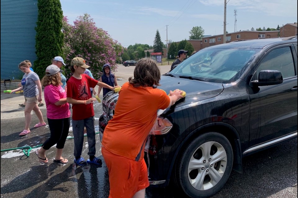 Students from Central Avenue Public School wash vehicles to raise funds for their class trip