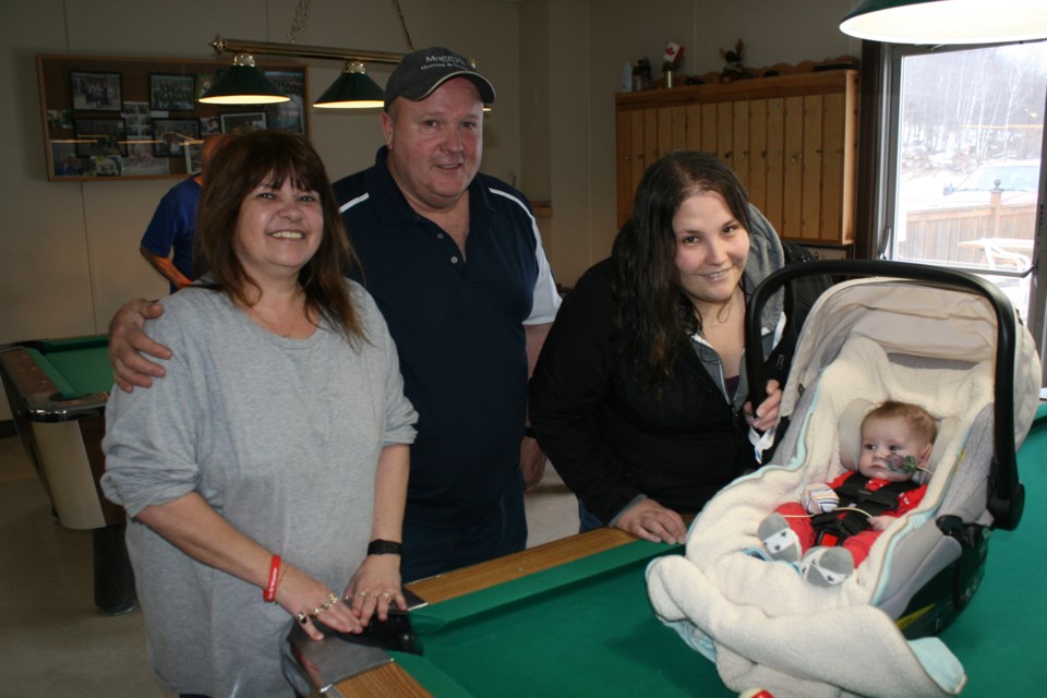 Saturday’s nine-ball pool tournament organizers Darin and Joanna Moggy of the Elliot Lake eight-ball pool league, welcome Elijah Hennessey and his mother Jessie to the tournament at the Moose Lodge. The event raised $1,009 for Elijah’s ongoing medical treatment. (photo by Kris Svela)