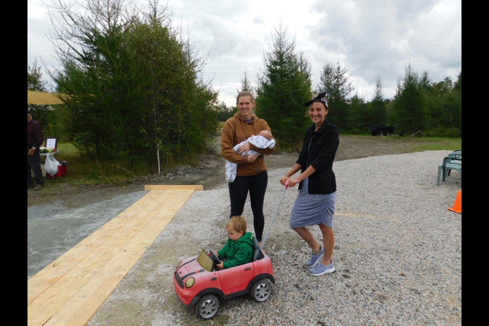 Marian, Landon and Beau St. Michel took part in the Pinecone Academy open house on Saturday and talked with co-founder Kendra Rogers (right). Children and parents took part in many of the activities at the event.