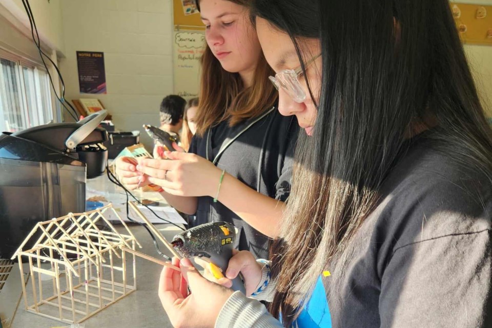 Grade 8 students recently employed math skills and materials provided to build mini-homes. 