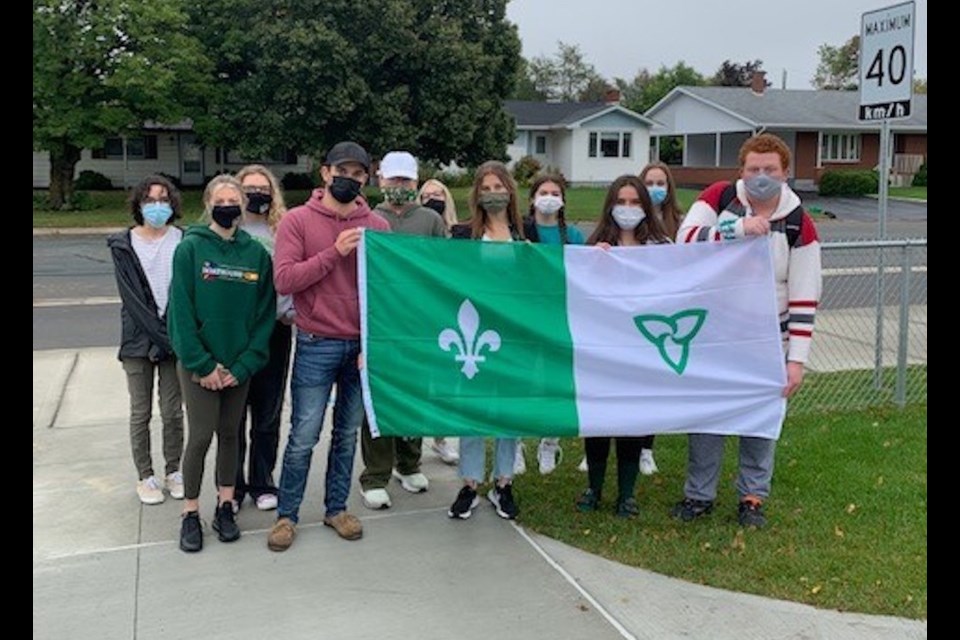 Students from École catholique La Renaissance in Espanola marched to the location of their old school to retrieve their Franco-Ontarian flags that still flew there