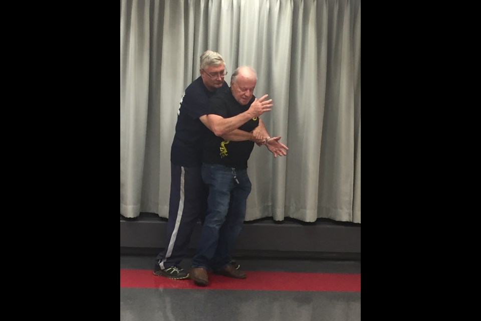 Members of In Motion fitness demonstrate self defence techniques.