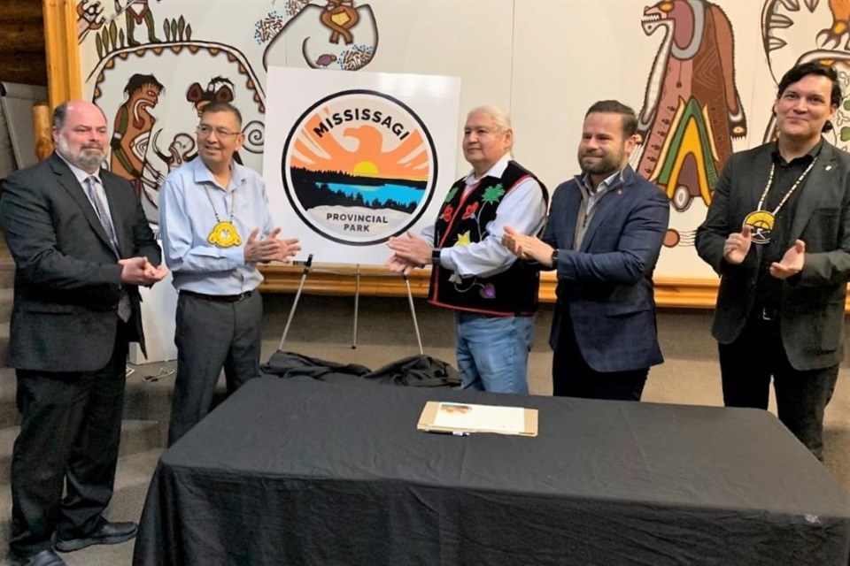 Mississaugi Provincial Park is now under an operating agreement between Elliot Lake, Serpent River First Nation (SRFN) and Mississauga First Nation (MFN). At a ceremony today the representatives signed the agreement and unveiled a new crest for the park. Taking part in the
unveiling of the crest was, from left, Acting Mayor Andrew Wannan, chief Bob Chiblow,
chairman of the Mississagi Park Foundation Jack Trudeau, Provincial minister David Piccini and chief Brent Bissaillion.