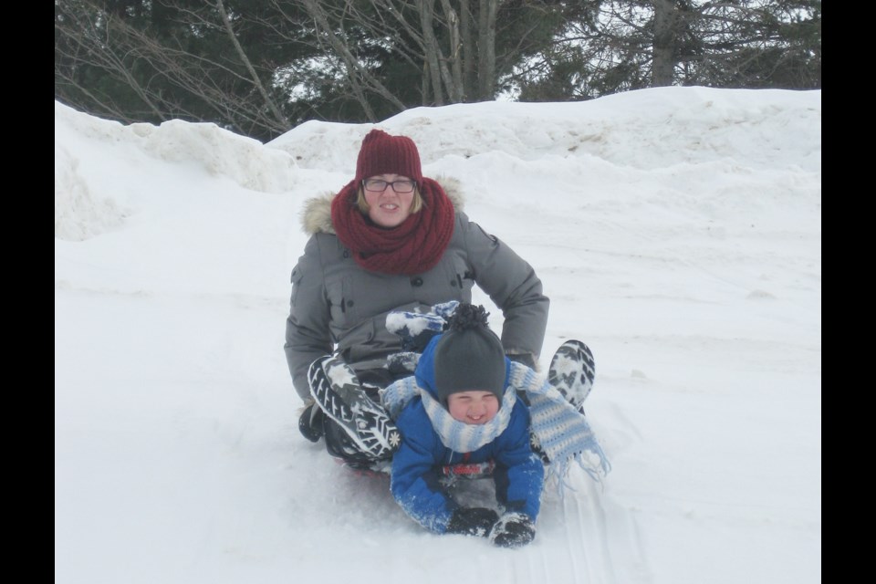 Four-year-old Jérémie Aubin decided sledding with his mother, Ashley Leblanc-Aubin, would be a fun time during part of the weekend Blind River Winter Carnival. Kris Svela/ElliotLakeToday