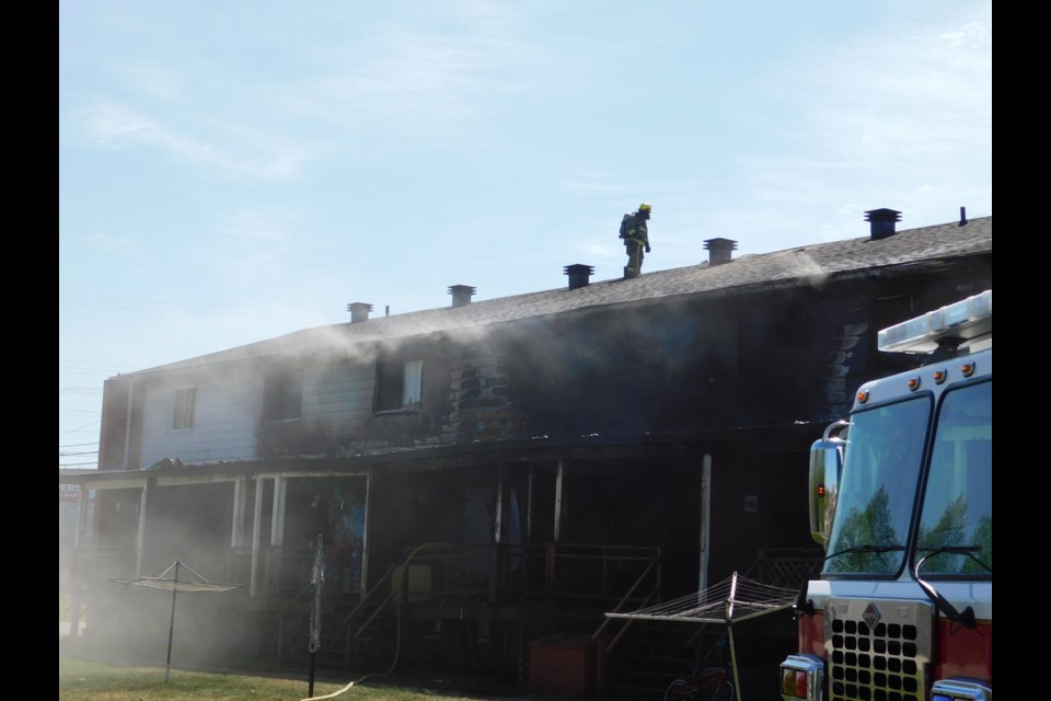 Fire crews remain on the scene of a large fire on Wednesday morning in an eight-unit rental townhouse complex.