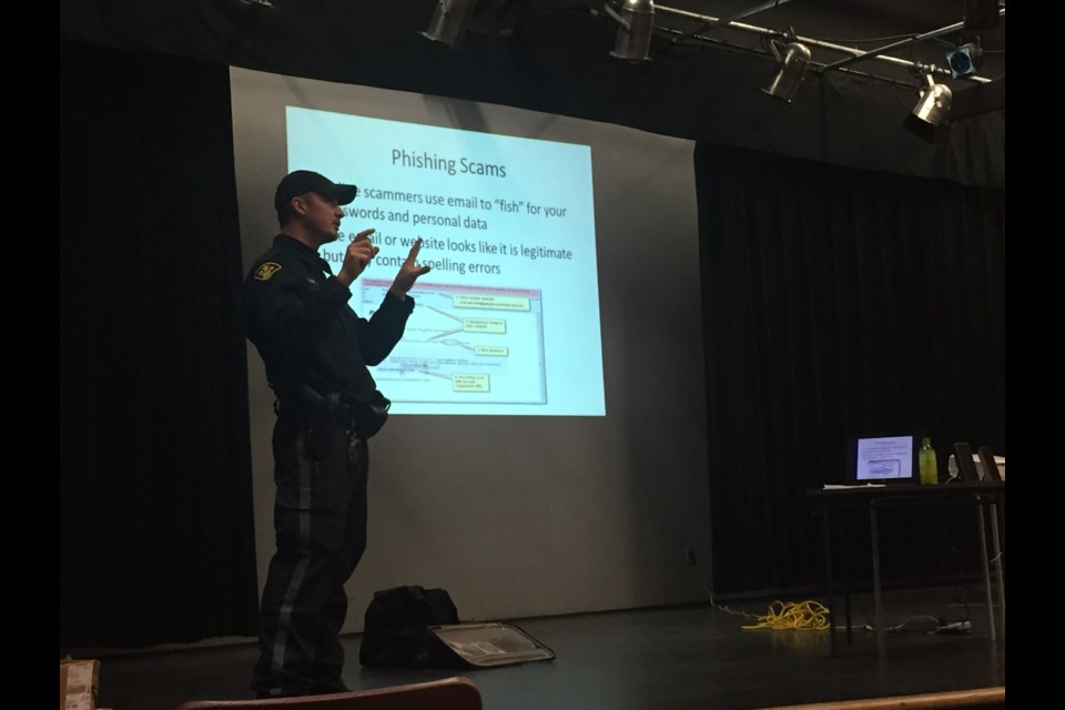 OPP Community Safety Officer Constable Phil Young explains to the crowd on how to protect themselves against scams and scams artists.
Melanie Farenzena/ ElliotLakeToday