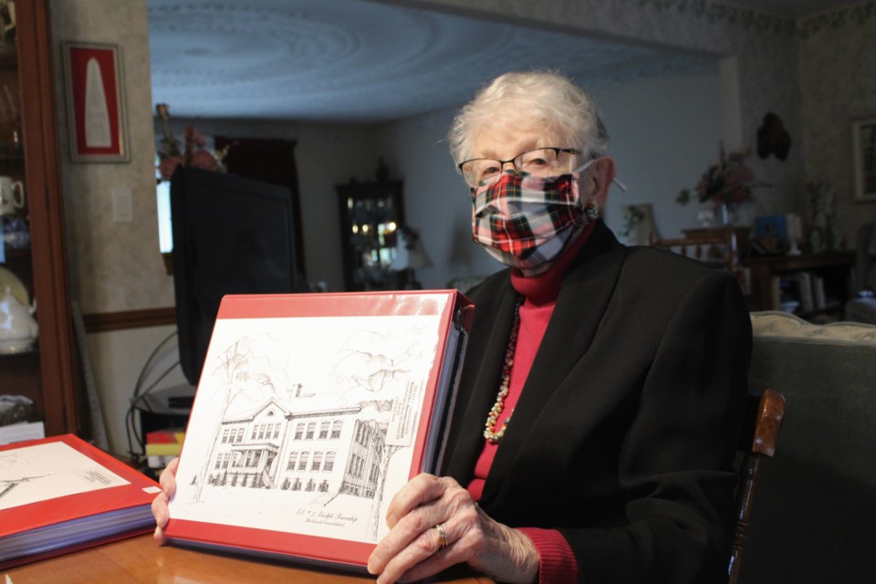 Marion Campbell, 90, drew each of the historic school houses for the book. Here she's pictured at her Marden home with a drawing of S.S. #7. 