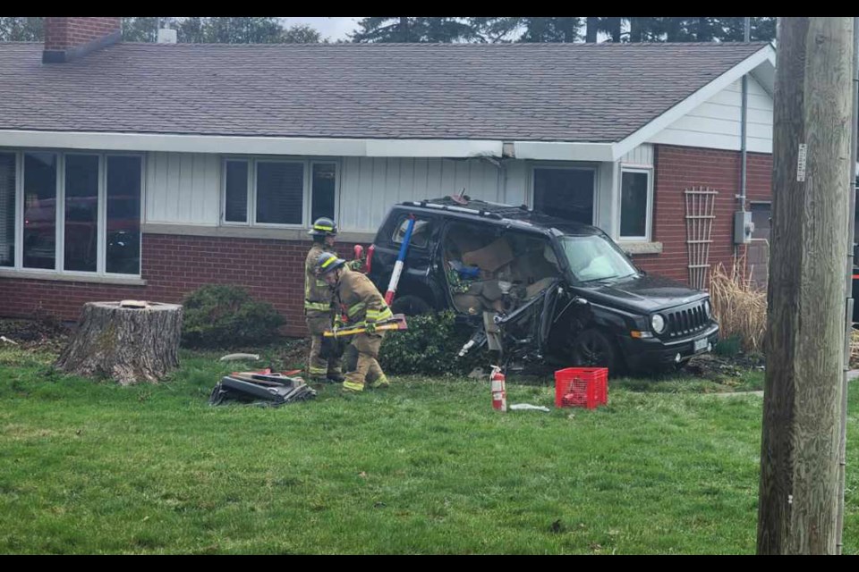 One of two vehicles involved in a collision east of Guelph on Wellington Road 124 Monday rests against the side of a house.