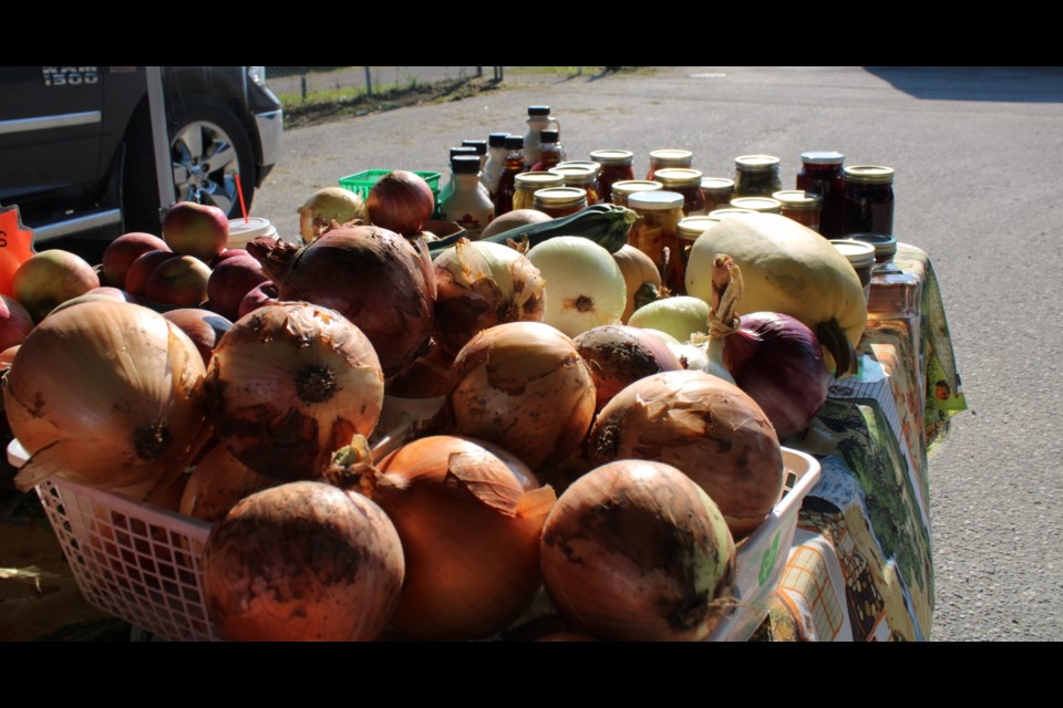 A huge pile of onions were for sale from a local Mennonite vendor.