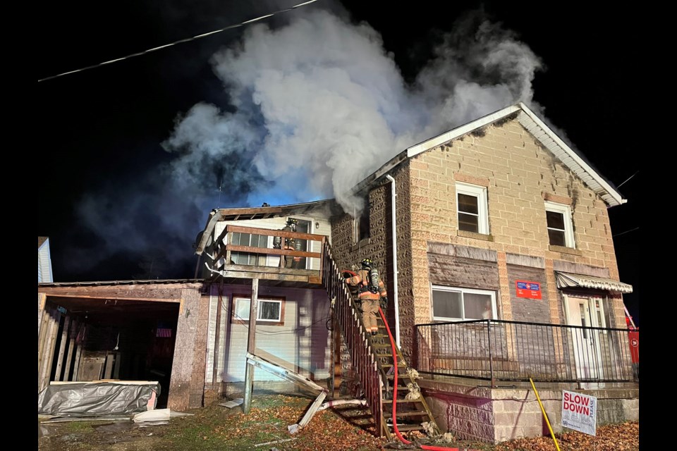 Firefighters from several departments battle an early morning fire in Belwood Tuesday. The multi-unit building also serves as the Belwood post office.